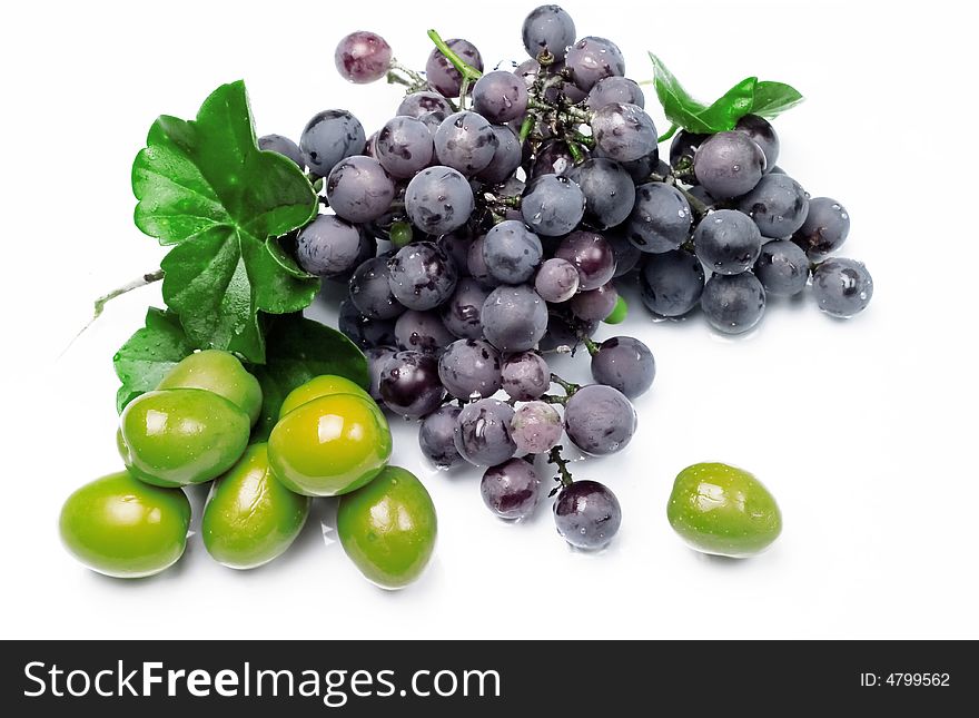 Delicious grape and olives isolated on white