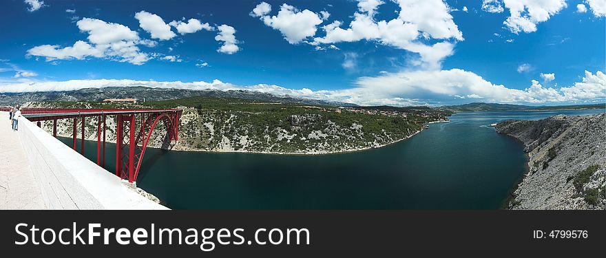 Red bridge over a bay, panoramic horizontal image. Red bridge over a bay, panoramic horizontal image