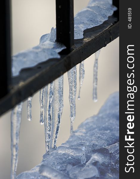 Icicles on a metal railing. Icicles on a metal railing