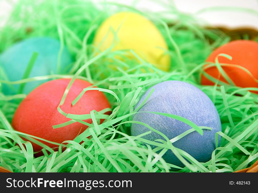 A macro of a group of easter eggs on a bed of grass. A macro of a group of easter eggs on a bed of grass.