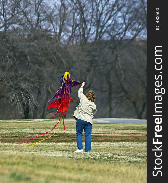 Mom helping children fly kite. Mom helping children fly kite