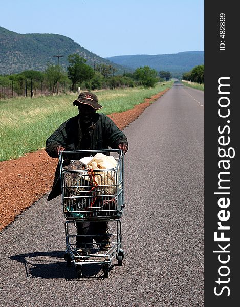 Man with shopping cart 50km from closest town. Man with shopping cart 50km from closest town