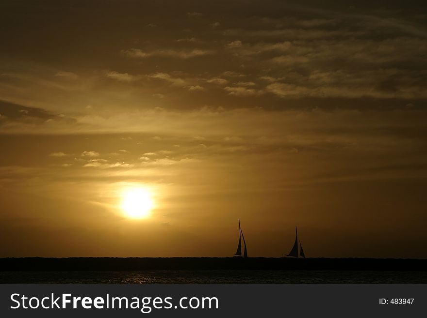 Silhouetted Sailboats at sunset