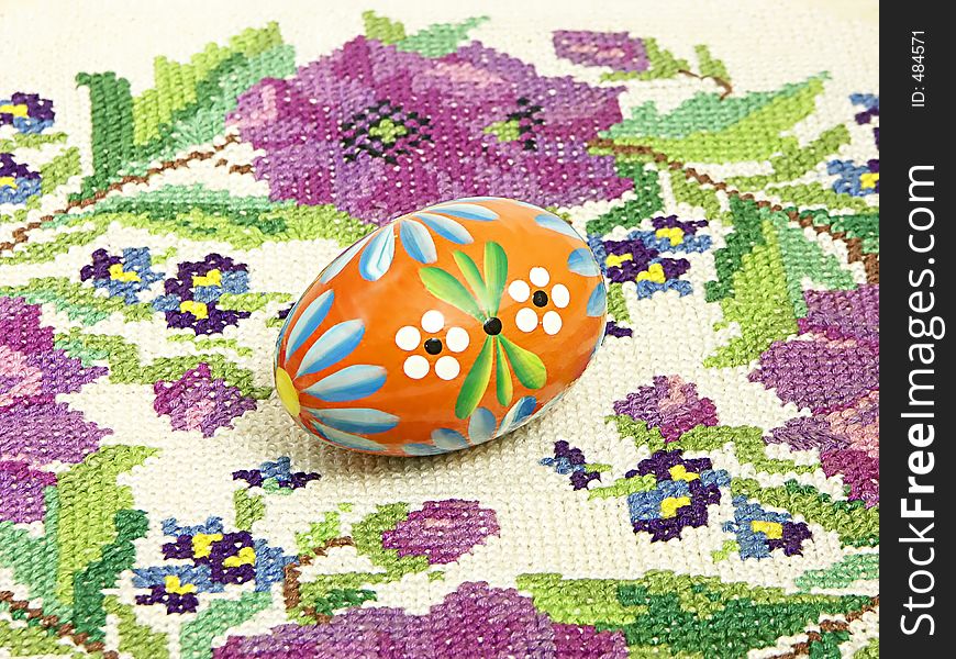 Traditional painted Easter egg over knitted tablecloth. Traditional painted Easter egg over knitted tablecloth