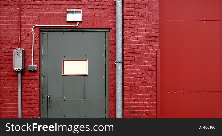 Grey door on red wall