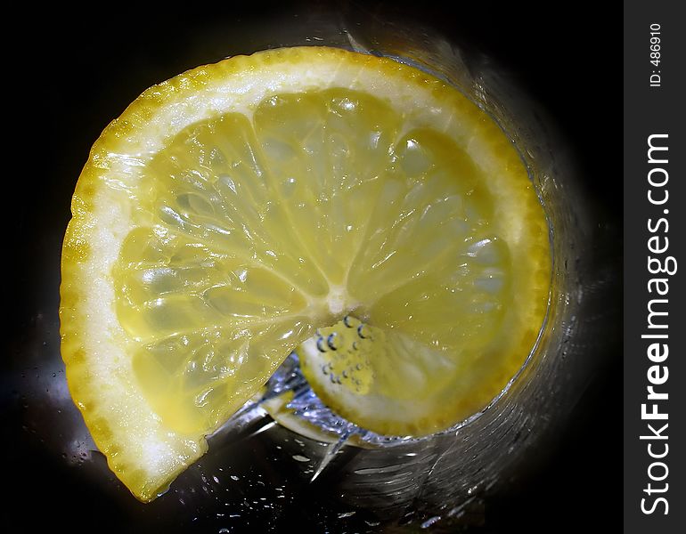 Lemon in a glass with soda-water. Lemon in a glass with soda-water