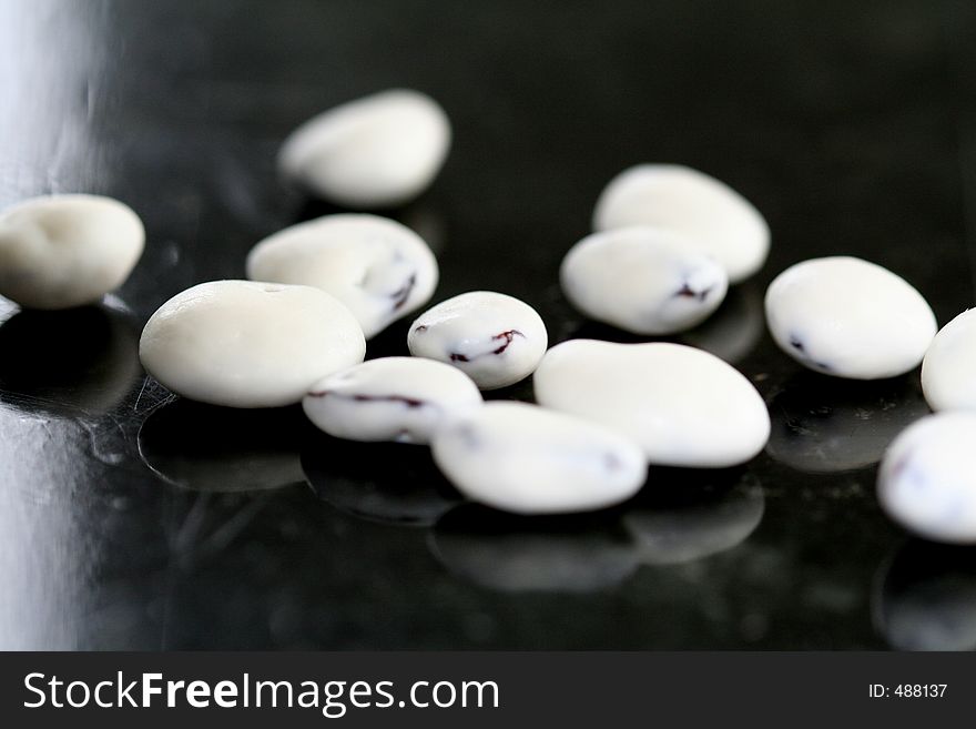 Closeup of yogurt covered raisins on black marble