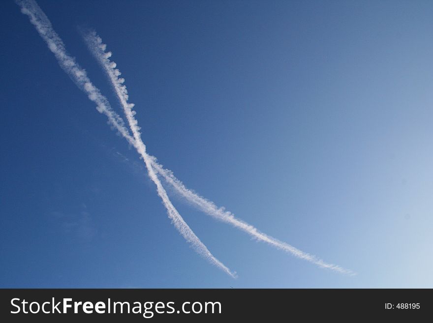 Crossing vapour trails left by jet engines. Crossing vapour trails left by jet engines