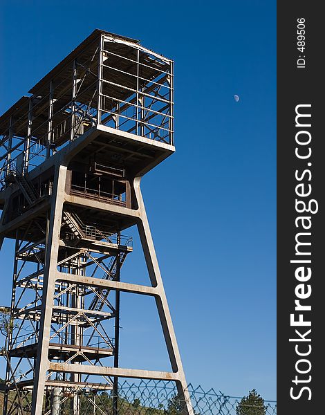 Ancient mining tower over a blue sky with the moon. Ancient mining tower over a blue sky with the moon