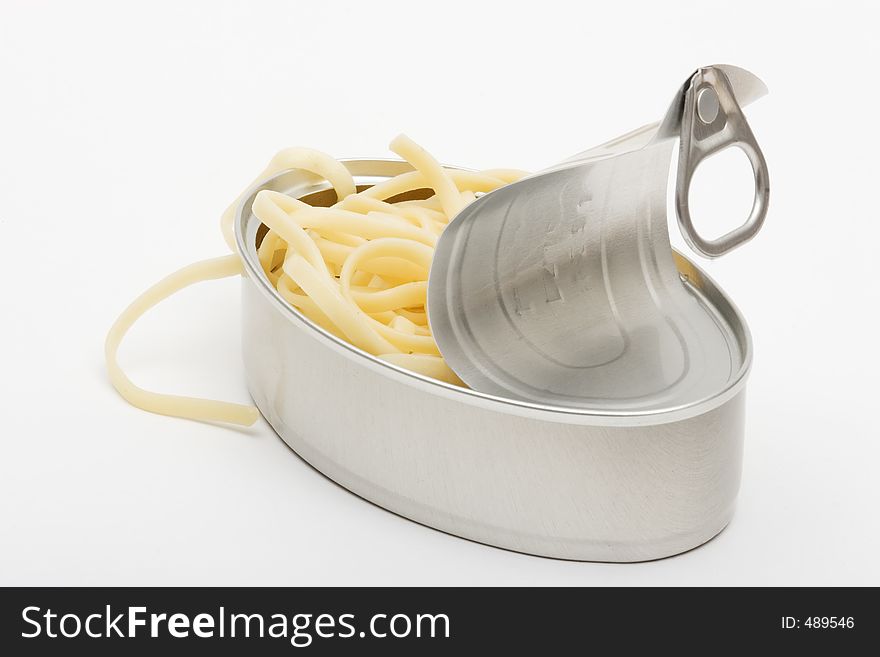 Cooked spaguetti in an open can. Cooked spaguetti in an open can