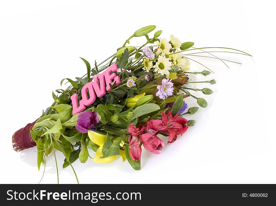 Flower arrangement on reflective surface, white background, studio shot