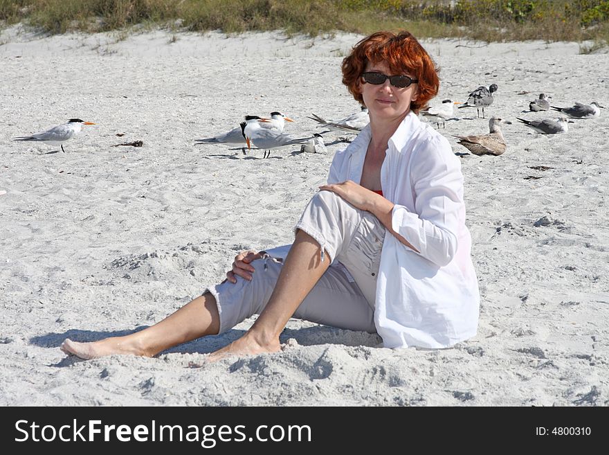 Girl on the beach with seagulls in the background. Girl on the beach with seagulls in the background