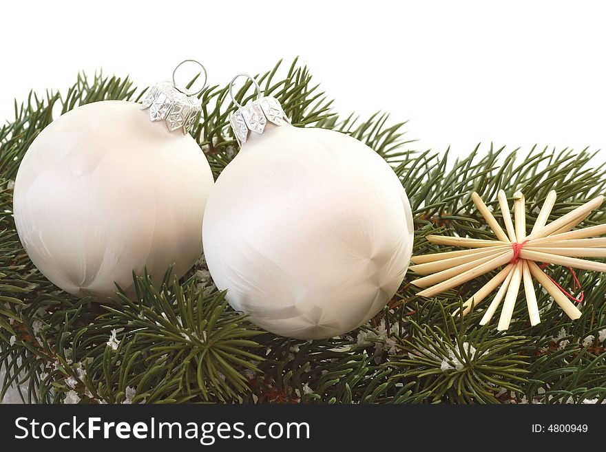 Two white christmas tree balls on a fir branch. Two white christmas tree balls on a fir branch