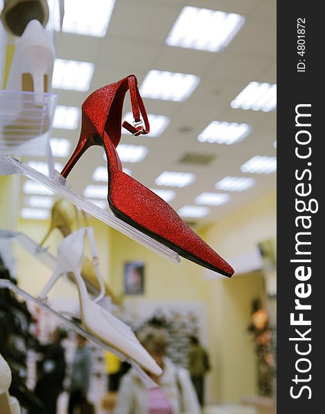 Fashionable red shoe in modern shoe store