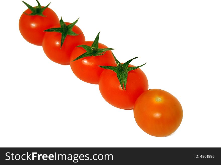 Five cherry tomatoes on a white background. Food ingredients