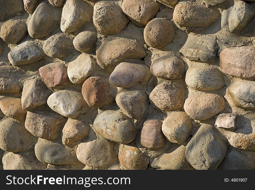 Stone wall made of round granite cobblestones