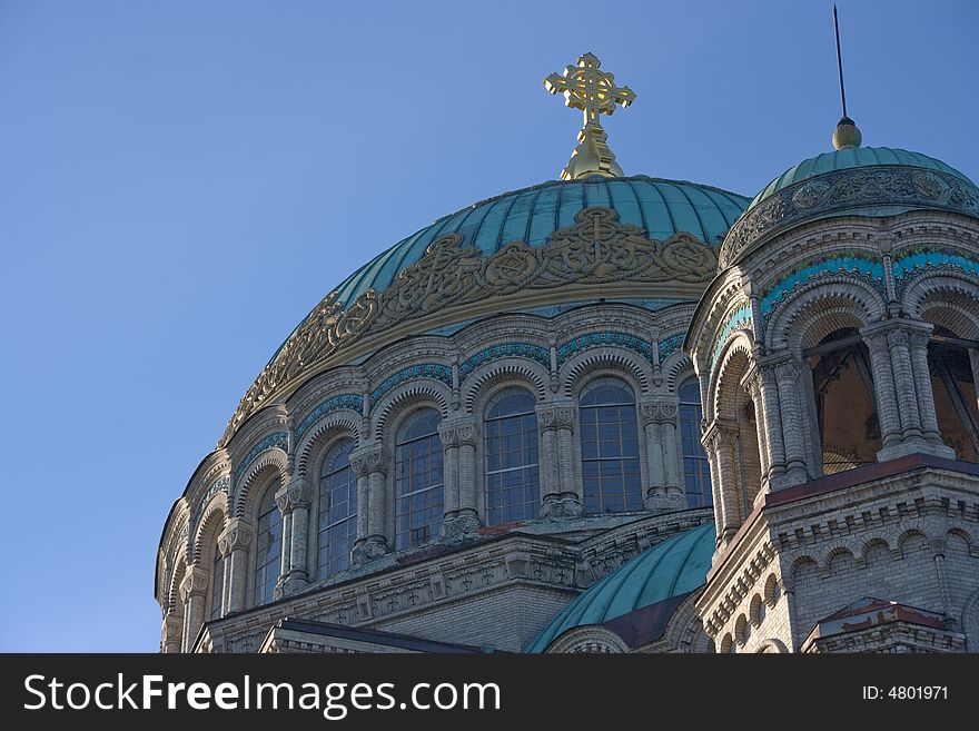 Cupolas of church with the cross against the background of the sky