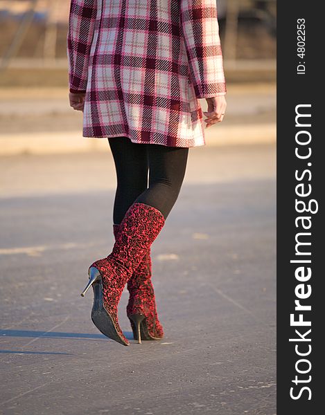 Woman is walking on a road. Woman is walking on a road