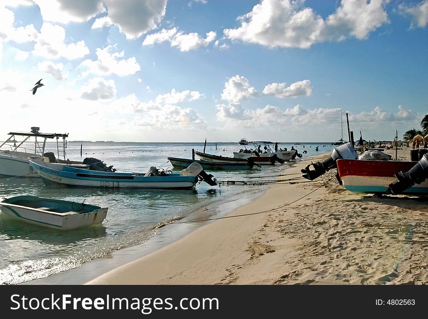 A view of ocean ,beach ,canoes and boats in beautiful cancun. A view of ocean ,beach ,canoes and boats in beautiful cancun