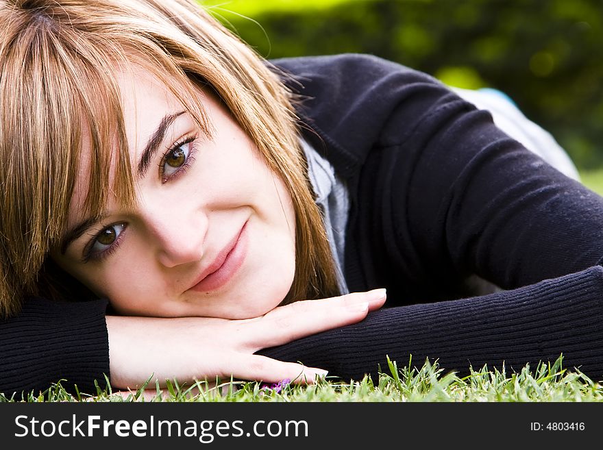 Smiling beauty on grass