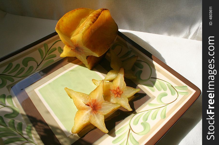 Star fruit on decorated plate. Star fruit on decorated plate.