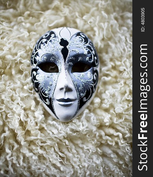 Mask on the a piece of sheep's wool