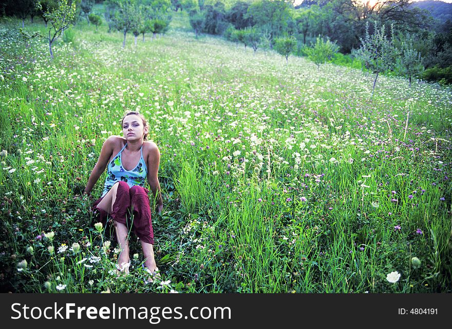 Teenage girl relaxing in meadow. Teenage girl relaxing in meadow