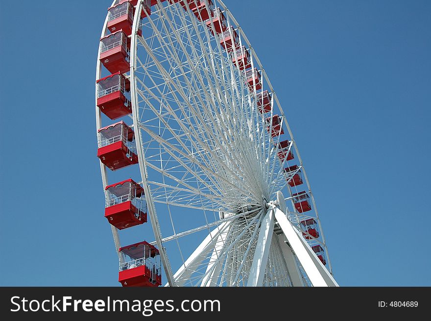 A huge red and white ferris wheel