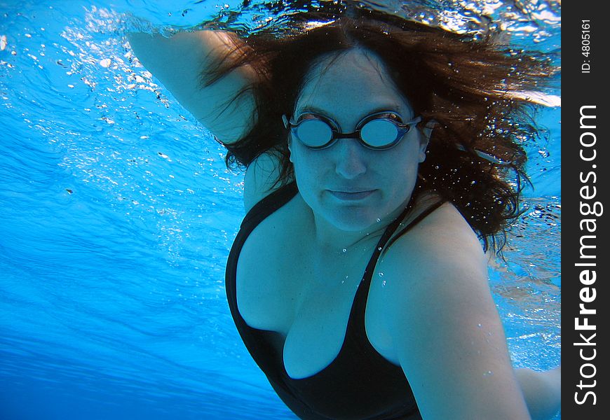 Woman swimming front crawl (aka freestyle) in pool in Papeete, Tahiti. Woman swimming front crawl (aka freestyle) in pool in Papeete, Tahiti.