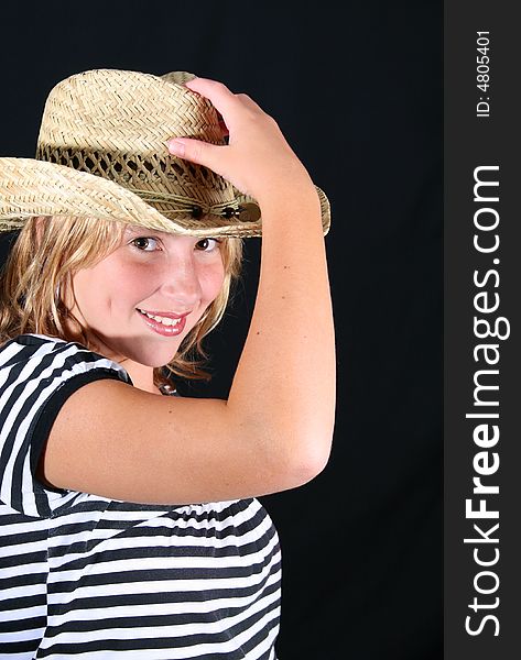 Teenage girl wearing a straw hat with a stripy top. Teenage girl wearing a straw hat with a stripy top