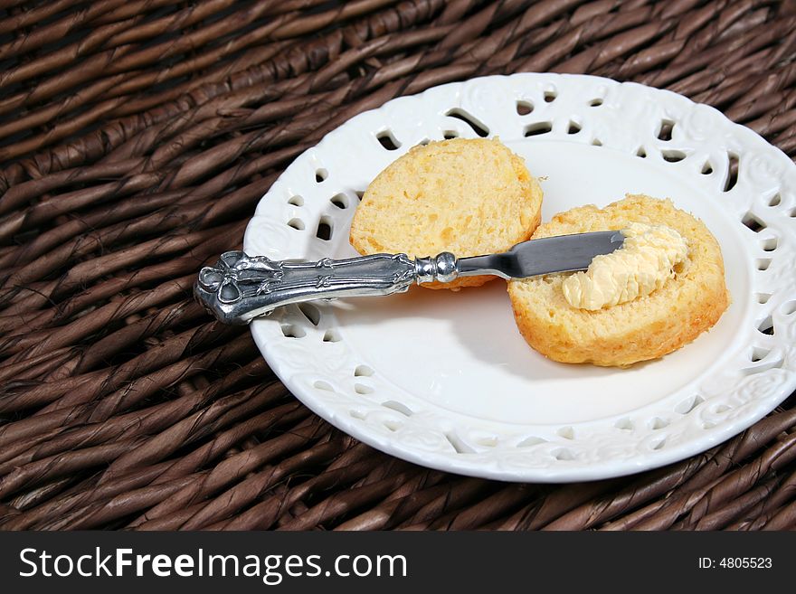 Early Moring Scones with butter on a white plate. Early Moring Scones with butter on a white plate