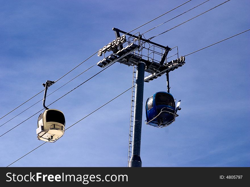 Two ski lift cabins passing