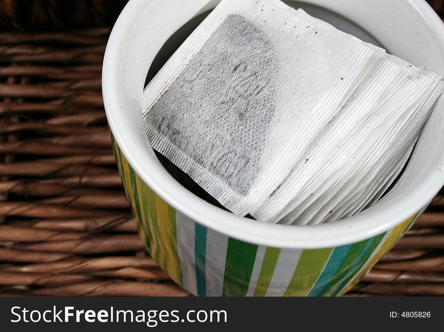 Tea Bags in a green striped ceramic container