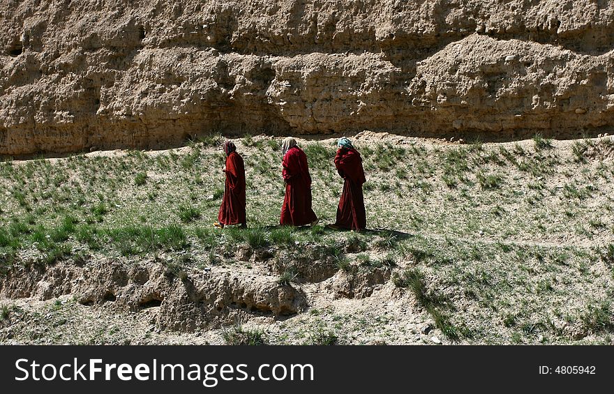 Three lamas are walking, taken from Tibet, China.