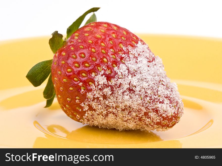 Strawberry with sugar on a yellow plate. Strawberry with sugar on a yellow plate