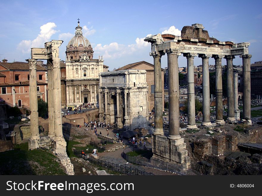 A view of the roman ruins in the crowded streets of rome. A view of the roman ruins in the crowded streets of rome