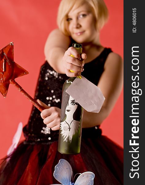 Girl hold hand-made bottle with blank label. Focus on the bottle.