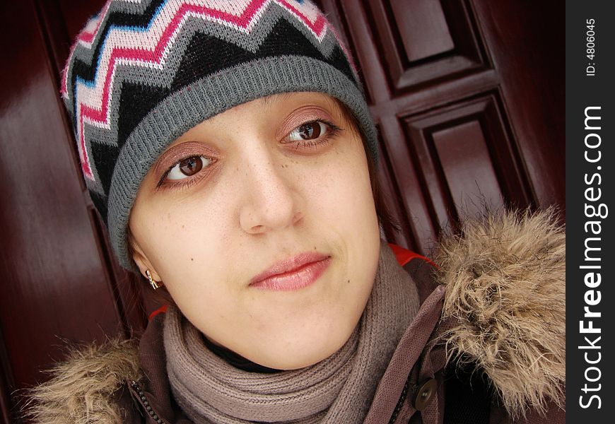 Closeup portrait of a girl in cap outdoors winter