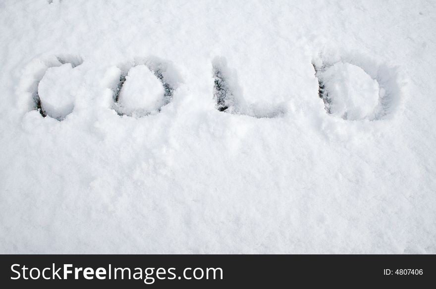 Snow on a surface with 'cold' written on it. Snow on a surface with 'cold' written on it.