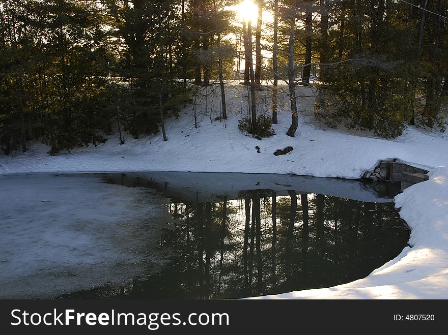 The afternoon sun lights up an icy pool and the snowbank in the foreground. The afternoon sun lights up an icy pool and the snowbank in the foreground.