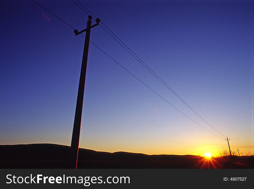 Telegraph pole silhouette in Sunset