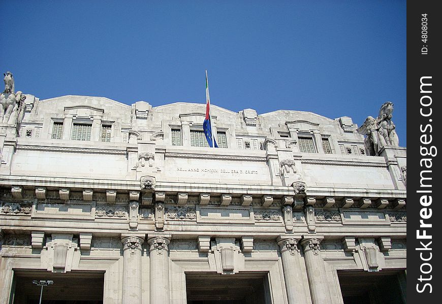 The entry of the train station of milan, under a blue sky. The entry of the train station of milan, under a blue sky