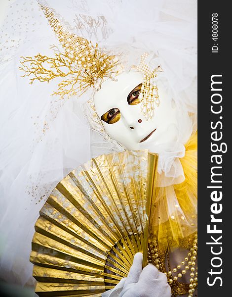 White costume and gold mask at the Venice Carnival. White costume and gold mask at the Venice Carnival