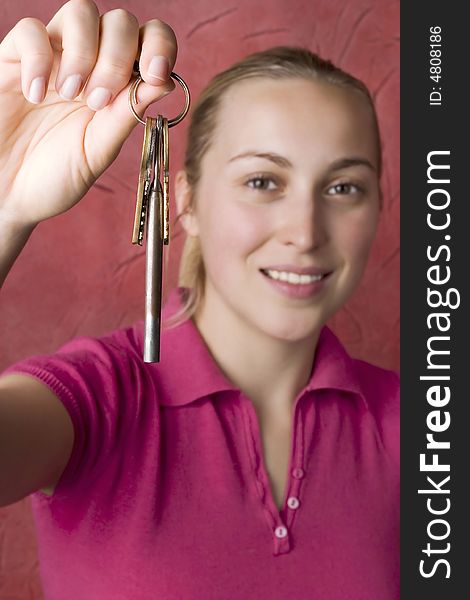 Woman with keys against the red background