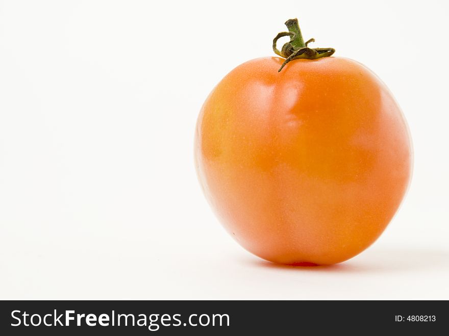 Ripe tomato on white background, shallow DOF