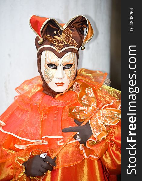 Orange costume with a butterfly at the Venice Carnival. Orange costume with a butterfly at the Venice Carnival