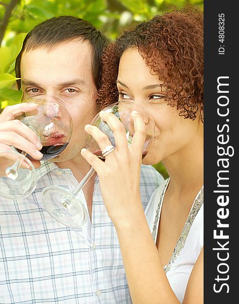 Very attractive young couple enjoying a glass of wine outdoors. Very attractive young couple enjoying a glass of wine outdoors