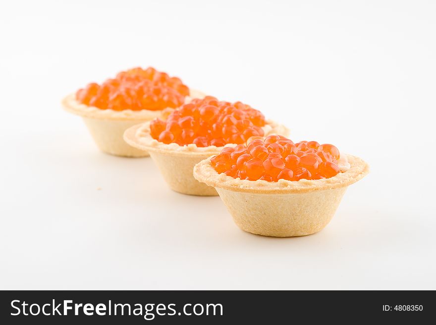 Tartlets with red caviar isolated on a white background. Tartlets with red caviar isolated on a white background