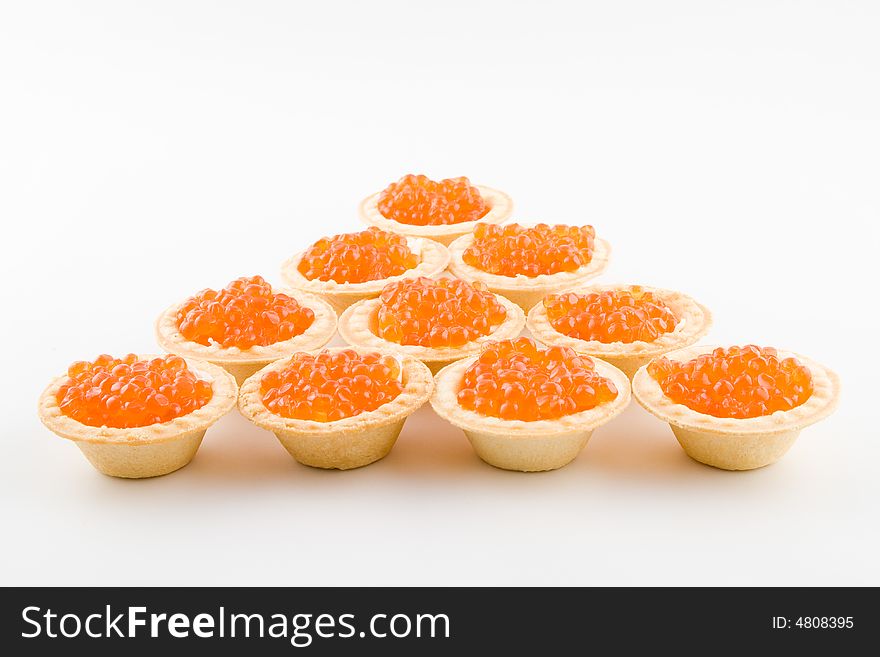 Tartlets with red caviar isolated on a white background. Tartlets with red caviar isolated on a white background