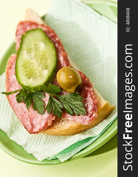 Food series: sandwich with salami, cucumber and olive